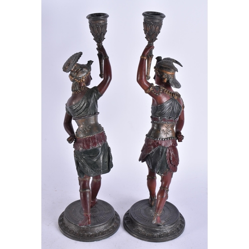 686 - A PAIR OF COLD PAINTED NATIVE AMERICAN FIGURAL CANDLESTICKS. 38 cm high.