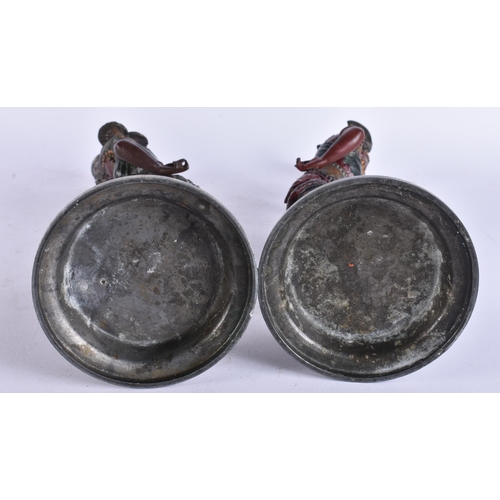 686 - A PAIR OF COLD PAINTED NATIVE AMERICAN FIGURAL CANDLESTICKS. 38 cm high.