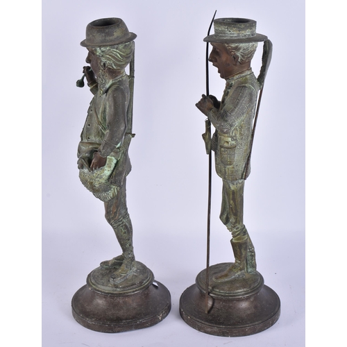 708 - A PAIR OF ART DECO SPELTER NOVELTY FISHERMAN CANDLESTICKS. 34 cm high.