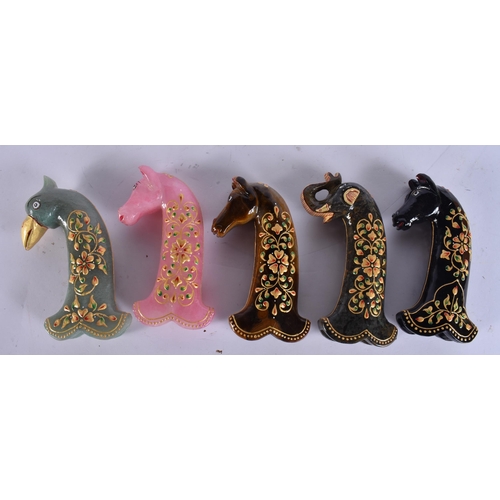 736 - FIVE ISLAMIC LACQUERED STONE DAGGER HANDLES. 17 cm long. (5)
