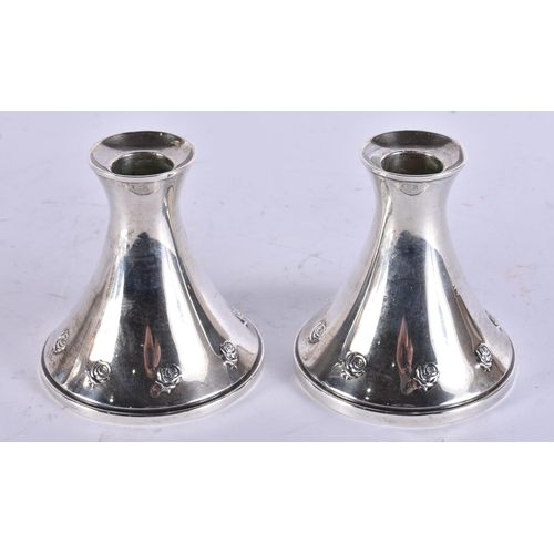 793 - A PAIR OF SILVER CANDLESTICKS. 642 grams overall. 9 cm high.
