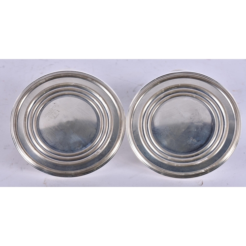 793 - A PAIR OF SILVER CANDLESTICKS. 642 grams overall. 9 cm high.