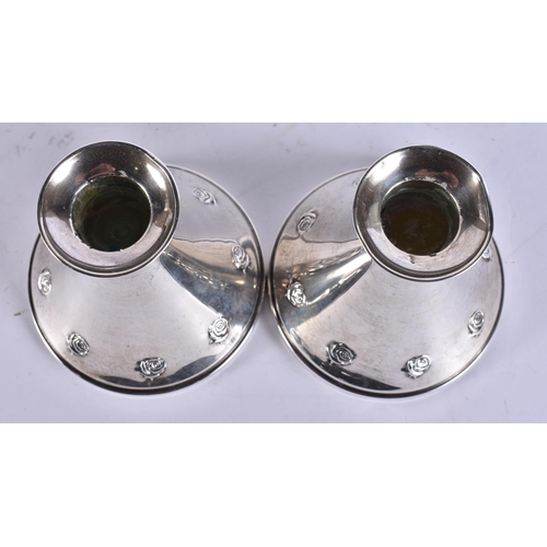 793 - A PAIR OF SILVER CANDLESTICKS. 642 grams overall. 9 cm high.
