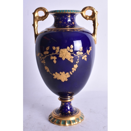 808 - Royal Crown Derby two handle vase with blue and gilt ground painted with a flying bird in landscape ... 
