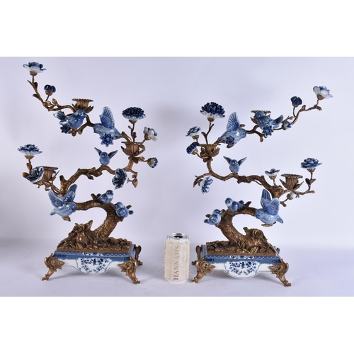 930 - A LARGE PAIR OF CONTINENTAL BLUE AND WHITE BRONZE AND PARROT CANDLESTICKS. 51 cm x 30 cm.