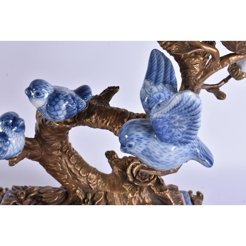 930 - A LARGE PAIR OF CONTINENTAL BLUE AND WHITE BRONZE AND PARROT CANDLESTICKS. 51 cm x 30 cm.