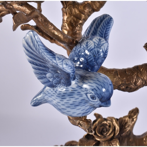 930 - A LARGE PAIR OF CONTINENTAL BLUE AND WHITE BRONZE AND PARROT CANDLESTICKS. 51 cm x 30 cm.