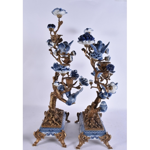 930 - A LARGE PAIR OF CONTINENTAL BLUE AND WHITE BRONZE AND PARROT CANDLESTICKS. 51 cm x 30 cm.