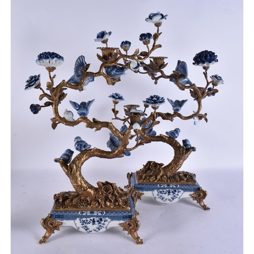 930 - A LARGE PAIR OF CONTINENTAL BLUE AND WHITE BRONZE AND PARROT CANDLESTICKS. 51 cm x 30 cm.