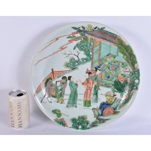 932 - A LARGE EARLY 18TH CENTURY CHINESE FAMILLE VERTE PORCELAIN DISH painted with ladies and others in a ... 