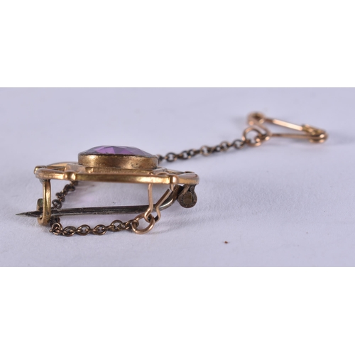 979 - A YELLOW METAL AND AMETHYST PENDANT. 3 grams. 2 cm wide.