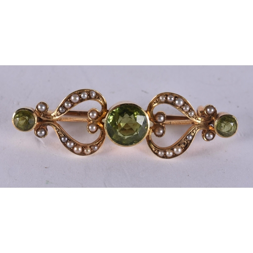 1218 - AN ANTIQUE YELLOW METAL PERIDOT AND PEARL B BROOCH. 4.3 grams. 4 cm x 1.25 cm.