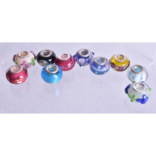 1362 - TEN SILVER MOUNTED CHARMS. 27 grams. (10)