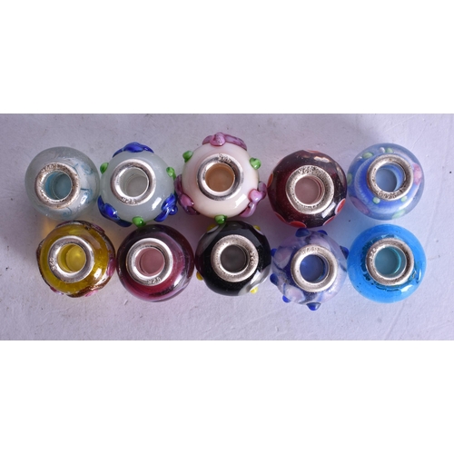 1362 - TEN SILVER MOUNTED CHARMS. 27 grams. (10)