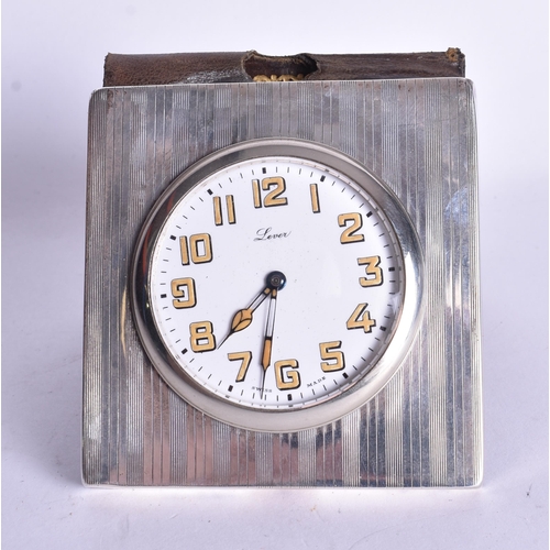 1524 - A Silver Cased Travel Clock with a fitted Leather Cover.  Not working.  Hallmarked London 1924.  7.6... 