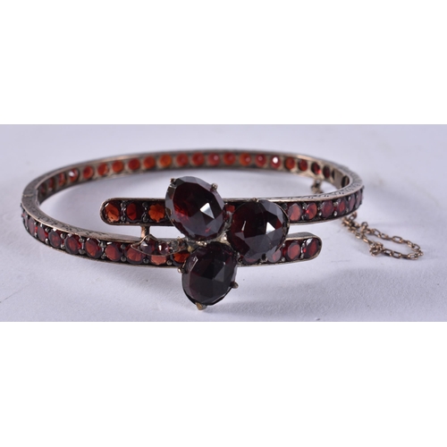 1604 - A Garnet Set Bangle.  5cm x 5.9cm, weight 16.2g