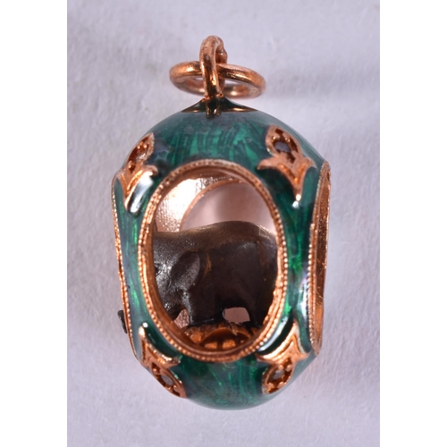 1641 - A Continental 14 Carat Gold Mounted Egg Pendant inset with an Elephant .  Stamped 56, 2.7cm x 1.3cm,... 