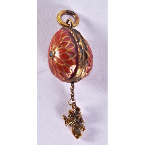 1653 - A Continental Silver and Red Enamel Egg Locket Pendant.  Stamped 84.  4.6cm x 1.5cm, weight 8.8g