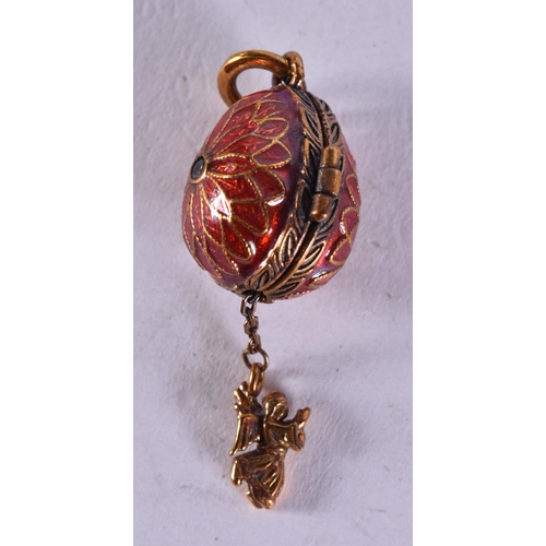 1653 - A Continental Silver and Red Enamel Egg Locket Pendant.  Stamped 84.  4.6cm x 1.5cm, weight 8.8g