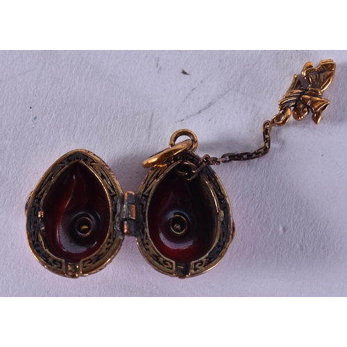 1653 - A Continental Silver and Red Enamel Egg Locket Pendant.  Stamped 84.  4.6cm x 1.5cm, weight 8.8g