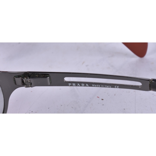 1911 - THREE PAIRS OF PRADA SUNGLASSES and another. (4)  WE ARE UNABLE TO SHIP THIS LOT TO THE USA OR CANAD... 
