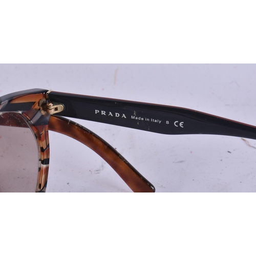 1911 - THREE PAIRS OF PRADA SUNGLASSES and another. (4)  WE ARE UNABLE TO SHIP THIS LOT TO THE USA OR CANAD... 