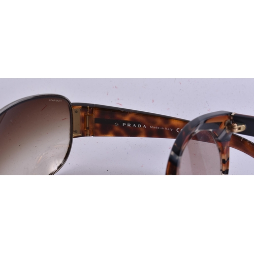 1911 - THREE PAIRS OF PRADA SUNGLASSES and another. (4)  WE ARE UNABLE TO SHIP THIS LOT TO THE USA OR CANAD... 