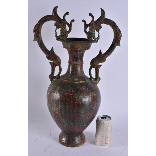 2028 - A LARGE CHINESE TWIN HANDLED BRONZE VASE incised with calligraphy. 50 cm x 28 cm.
