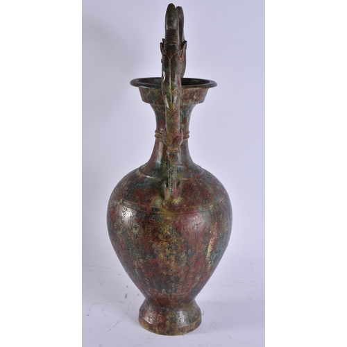 2028 - A LARGE CHINESE TWIN HANDLED BRONZE VASE incised with calligraphy. 50 cm x 28 cm.