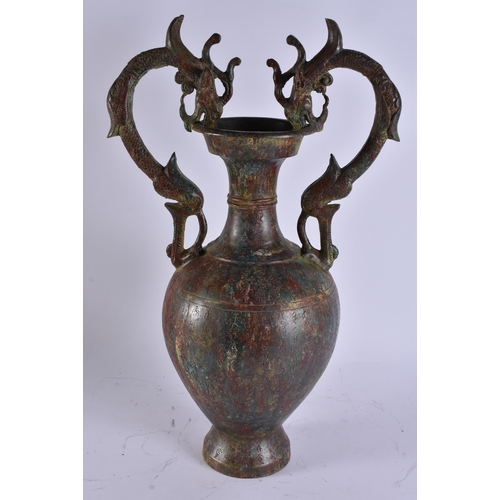 2028 - A LARGE CHINESE TWIN HANDLED BRONZE VASE incised with calligraphy. 50 cm x 28 cm.