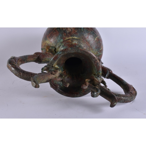 2028 - A LARGE CHINESE TWIN HANDLED BRONZE VASE incised with calligraphy. 50 cm x 28 cm.