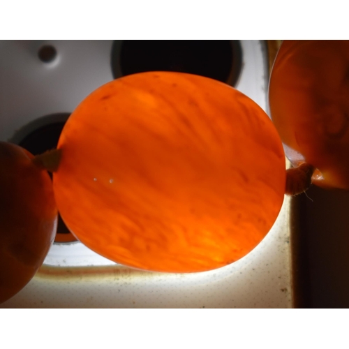 2049 - A BUTTERSCOTCH AMBER NECKLACE together with a cherry amber snuff bottle & a stone horse. Necklace 49... 