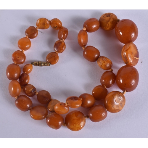 2049 - A BUTTERSCOTCH AMBER NECKLACE together with a cherry amber snuff bottle & a stone horse. Necklace 49... 