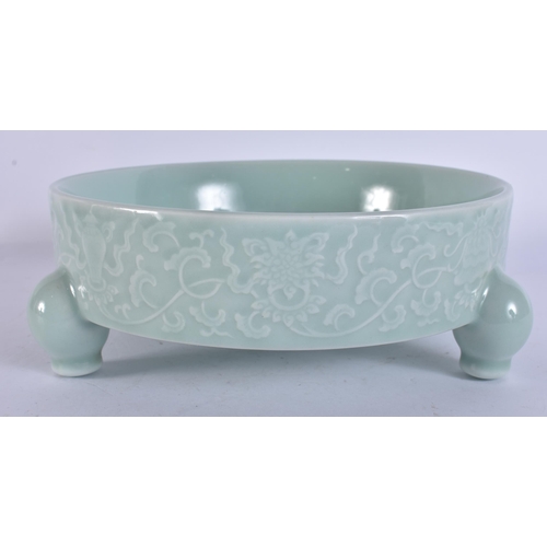 2104 - A CHINESE CELADON RAISED RELIEF DECORATED PORCELAIN CENSER. 18 cm wide.