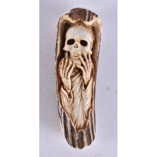 2227 - A STAG ANTLER MEMENTO MORI SKELETON. 56 grams. 10.25 cm x 3 cm.
