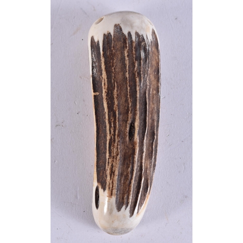 2227 - A STAG ANTLER MEMENTO MORI SKELETON. 56 grams. 10.25 cm x 3 cm.