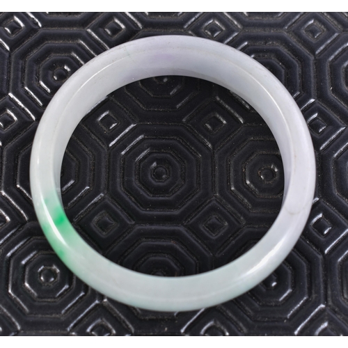 2323 - A CHINESE JADE BANGLE. 64 grams. 5.75 cm wide.