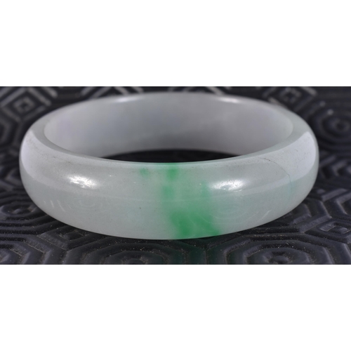 2323 - A CHINESE JADE BANGLE. 64 grams. 5.75 cm wide.