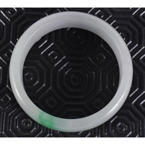 2323 - A CHINESE JADE BANGLE. 64 grams. 5.75 cm wide.