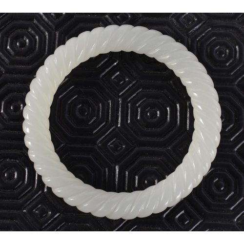 2346 - A CHINESE JADE BANGLE. 44 grams. 6 cm wide.