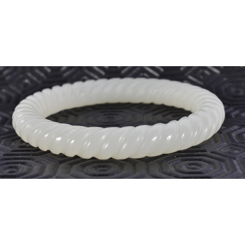 2346 - A CHINESE JADE BANGLE. 44 grams. 6 cm wide.