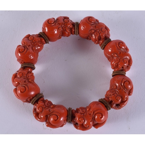 2369 - A CHINESE CORAL NECKLACE and a bracelet. 149 grams. Largest 95 cm long. (2)