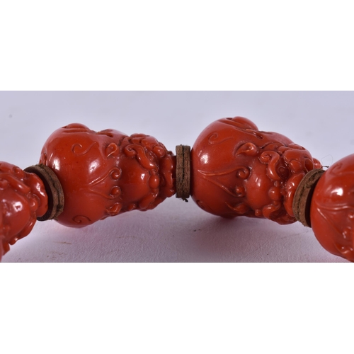 2369 - A CHINESE CORAL NECKLACE and a bracelet. 149 grams. Largest 95 cm long. (2)