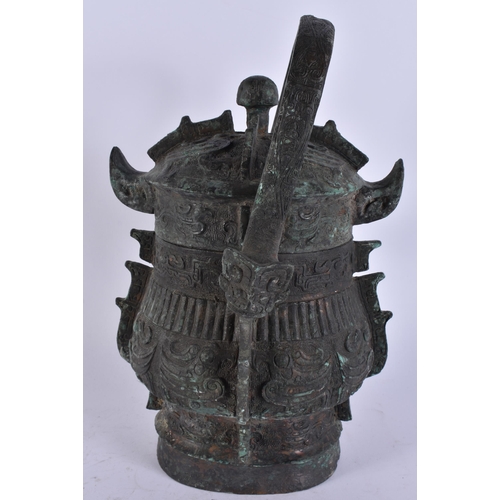2483 - A RARE CHINESE QING DYNASTY BRONZE SWING HANDLED VESSEL AND COVER. 29 cm high inc handle.