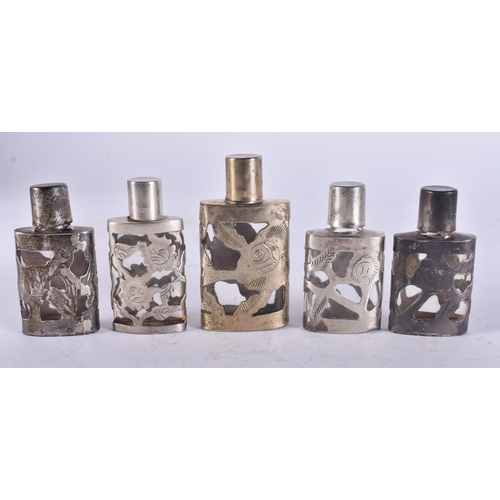 2579 - FIVE SILVER OVERLAID SCENT BOTTLES. 101 grams overall. 6.25 cm high. (5)