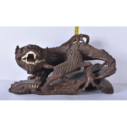 3041 - A large Japanese hardwood carving of a Mythical beast 18 x 32cm