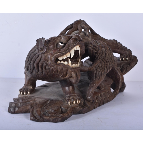 3041 - A large Japanese hardwood carving of a Mythical beast 18 x 32cm