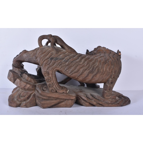 3041 - A large Japanese hardwood carving of a Mythical beast 18 x 32cm
