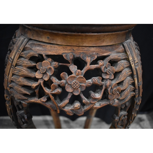 3180 - A Chinese carved hardwood stand with a marble insert 95 x 40cm