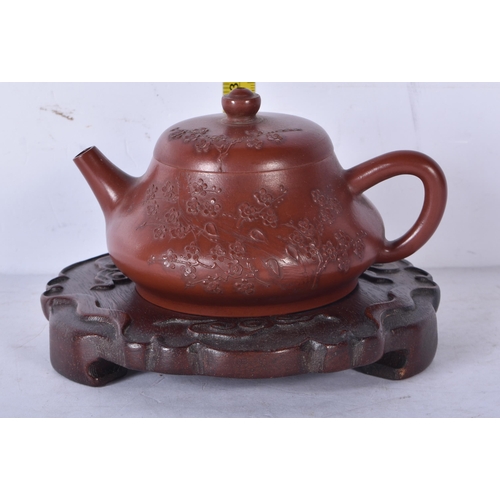 3229 - A Chinese Yixing teapot with a fitted Hardwood stand 9 x 14cm (2)